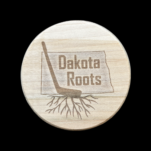 Dakota Roots Puck with players last name and jersey number on the back